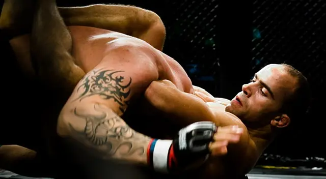 Fighters engaged in a Vale Tudo match showcasing grappling techniques and Brazilian Jiu Jitsu influence in mixed martial arts.