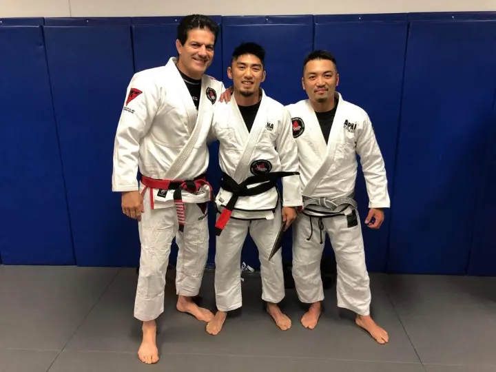 Master Jean Jacques Machado with Xavier Sales and Chris Sales at Alpha Jiu Jitsu Academy, highlighting mentorship and BJJ expertise.