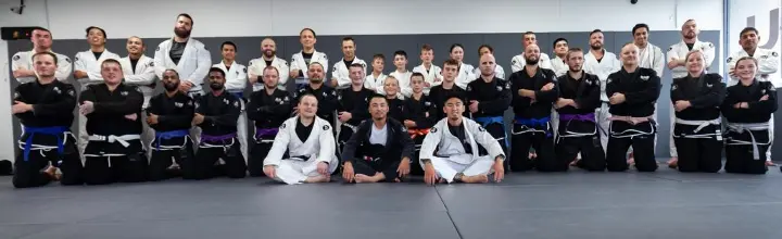 Large group photo of instructors and students from Alpha Jiu Jitsu Academy, demonstrating unity and dedication to Brazilian Jiu Jitsu training.