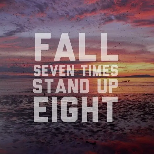 Inspirational quote "Fall Seven Times, Stand Up Eight" over a sunset background, symbolizing resilience and perseverance.