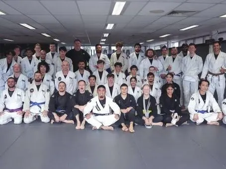 Professor Xavier leading a Brazilian Jiu Jitsu class with adult students at Alpha Jiu Jitsu Academy inside the gym