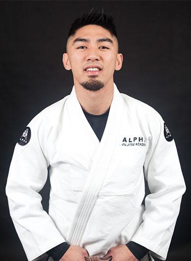 Professor Xavier Sales of Alpha Jiu Jitsu Academy wearing a gi, showcasing leadership and expertise in Brazilian Jiu Jitsu training.